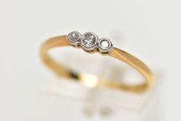 AN 18CT GOLD THREE STONE DIAMOND RING, to the centre is a collet set old cut diamond, flanked with