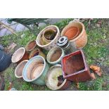SIXTEEN GLAZED AND TERRACOTTA PLANT POTS and a pedestal stand tallest being 37cm in diameter and