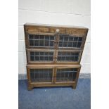 AN EARLY 20TH CENTURY OAK SECTIONAL BOOKCASE, made up of three tier that have double lead glazed