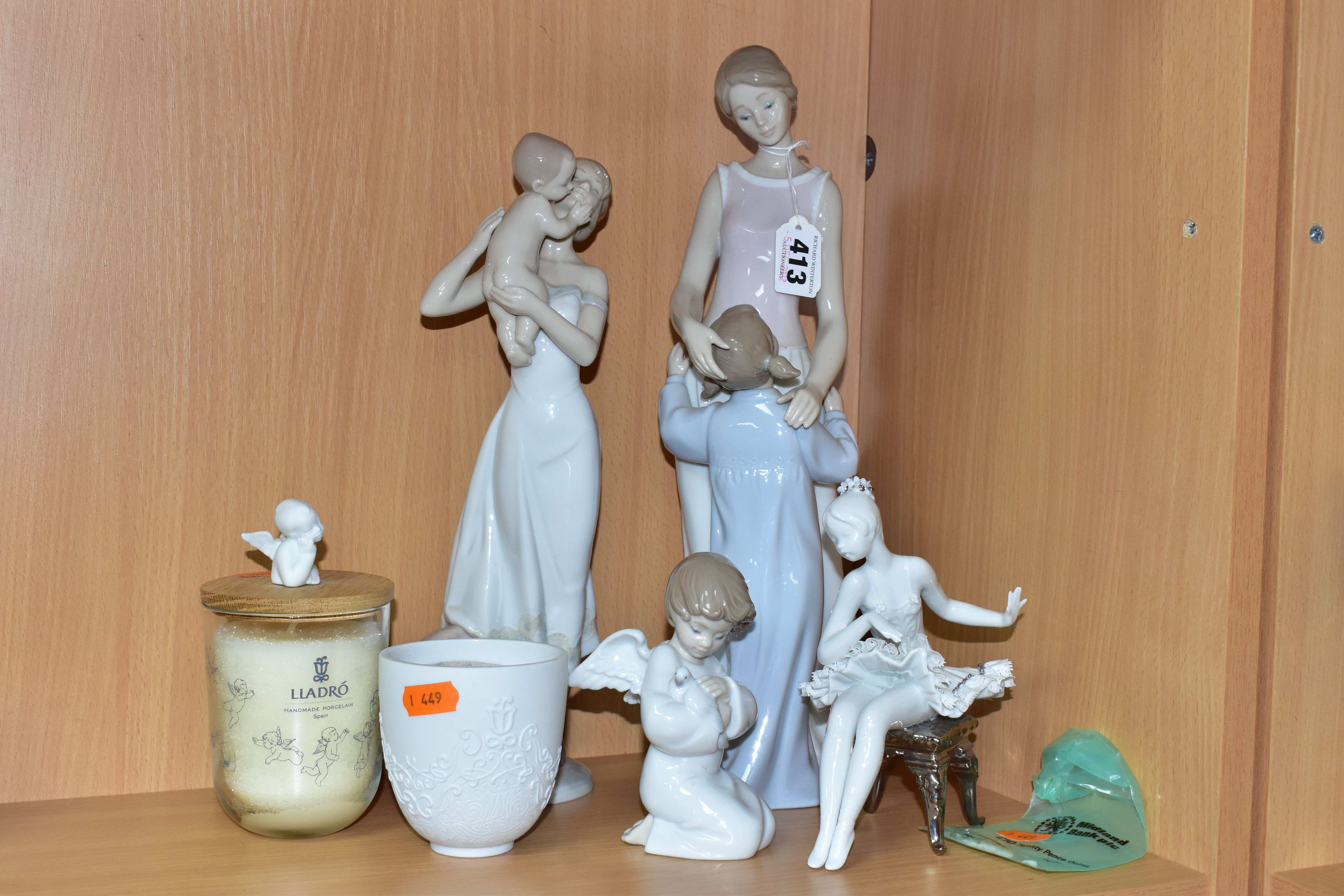 A GROUP OF LLADRO FIGURINES AND CANDLES, comprising four figurines: 'Loving Protection' 8245