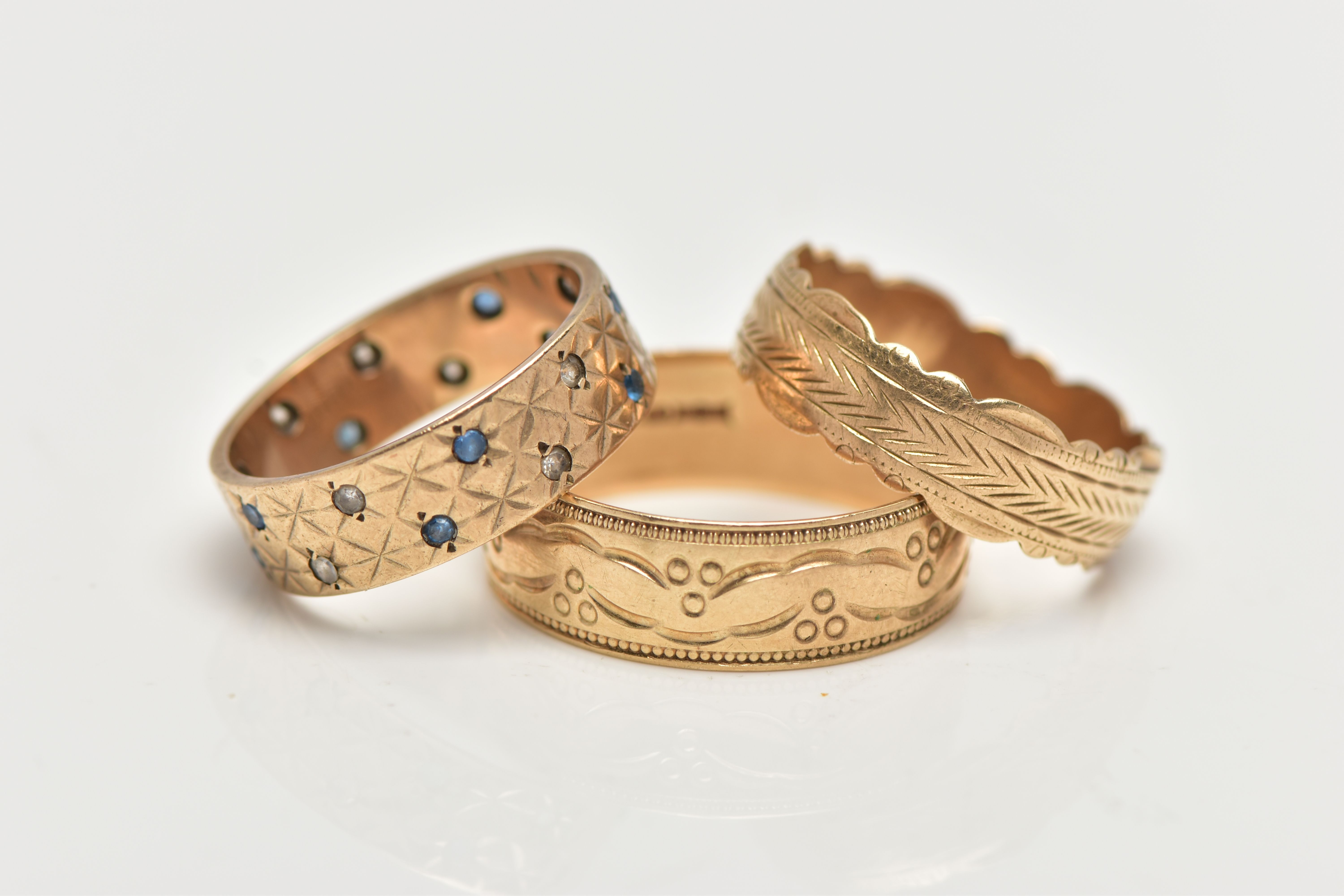 THREE 9CT GOLD BAND RINGS, the first a wide band set with small blue sapphires and spinels, with a - Image 2 of 3