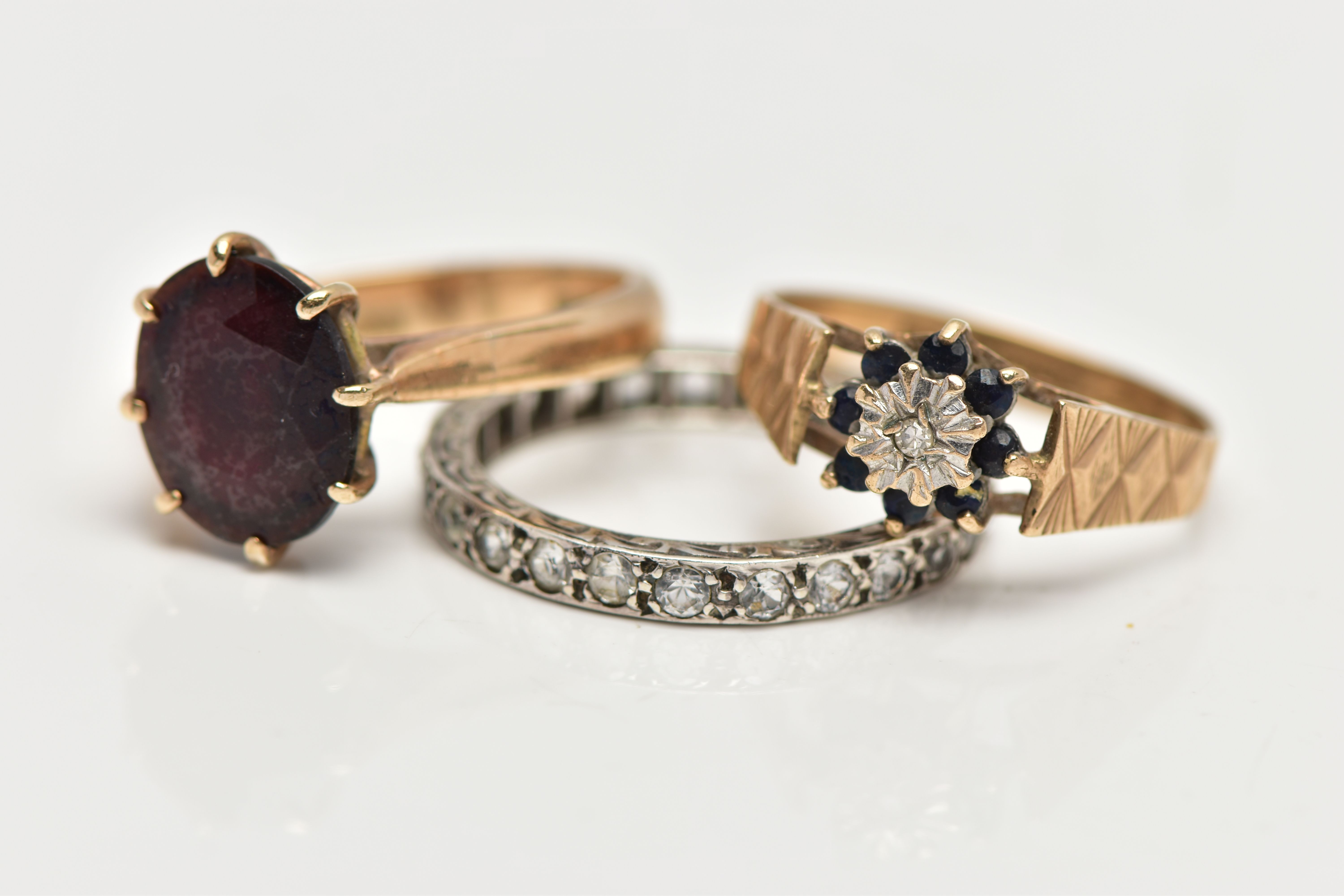 THREE GEM SET RINGS, the first designed with an oval cut garnet in an eight claw setting with - Image 3 of 4
