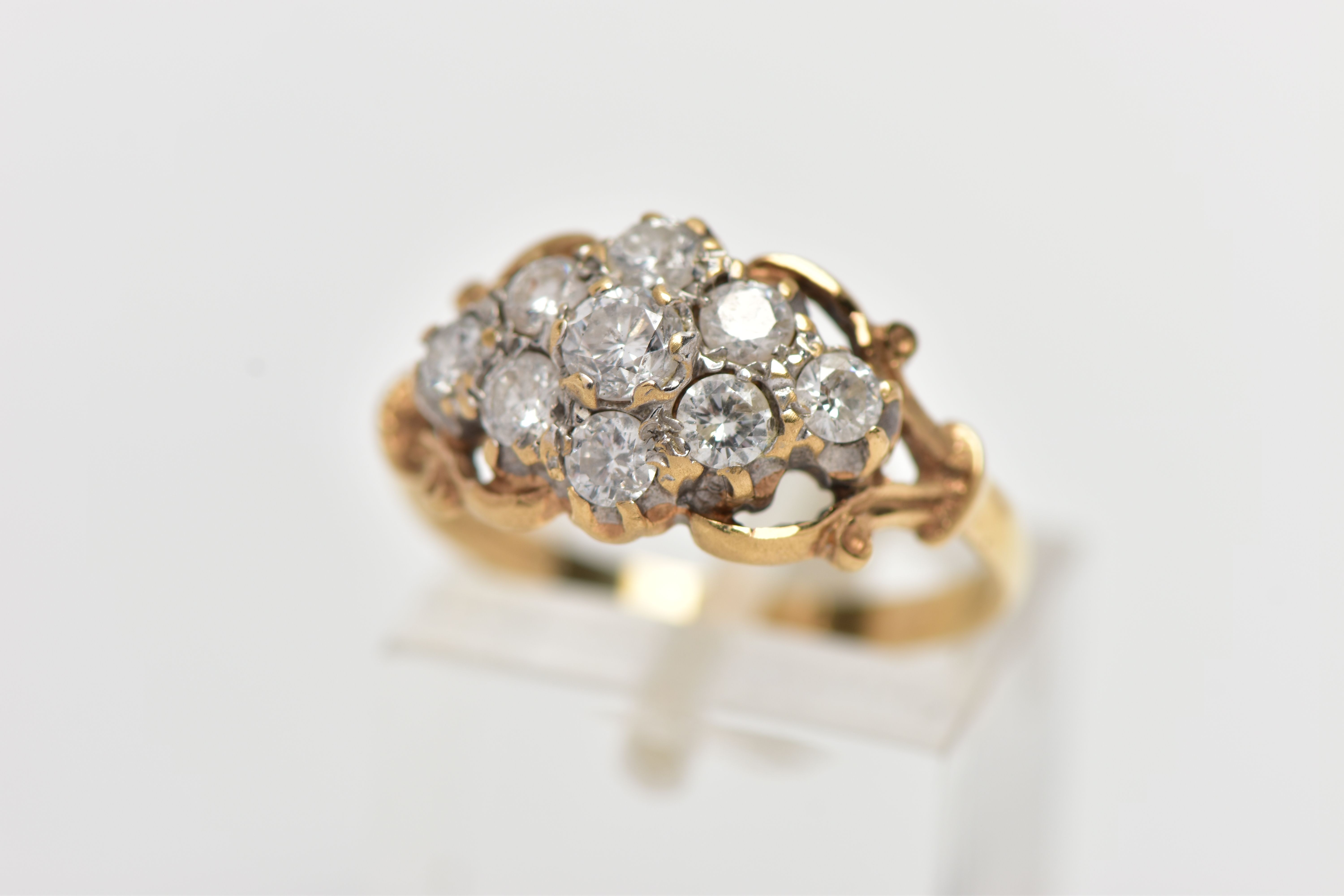 A 9CT YELLOW GOLD DIAMOND CLUSTER RING, of a lozenge shape, set with nine claw set round brilliant