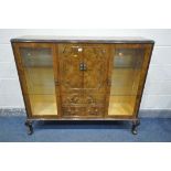 A QUEEN ANNE STYLE WALNUT SIDE BY SIDE BOOKCASE, with bevelled glazed doors, flanking double