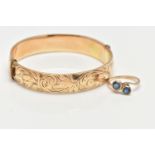 A 9CT GOLD SAPPHIRE RING AND A GOLD PLATED HINGED BANGLE, the ring of a cross over design, set