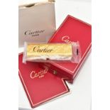 AN UNUSED GOLD PLATED 'CARTIER' LIGHTER, unopened gold plated textured lighter, signed to the