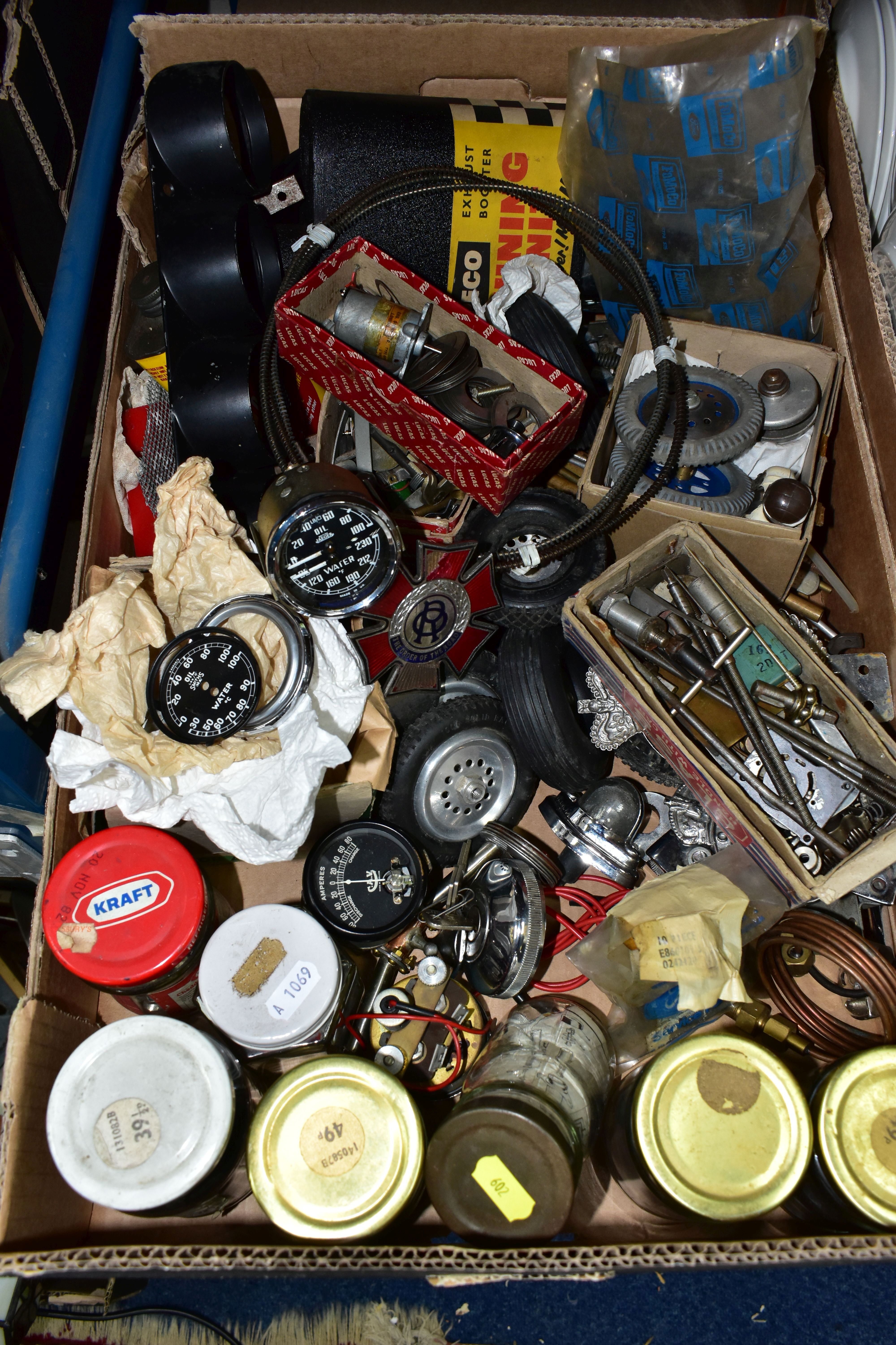 A BOX OF ASSORTED SPARE CAR RELATED AND MODEL CAR SPARE PARTS ETC, to include an unused Peco exhaust