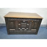 A CARVED OAK COFFER, made up from an accumulation of various period timbers, the front with