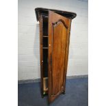 AN ANTIQUE FRUITWOOD SINGLE DOOR ARMOIRE, with an overhanging cornice, width 89cm x depth 76cm x