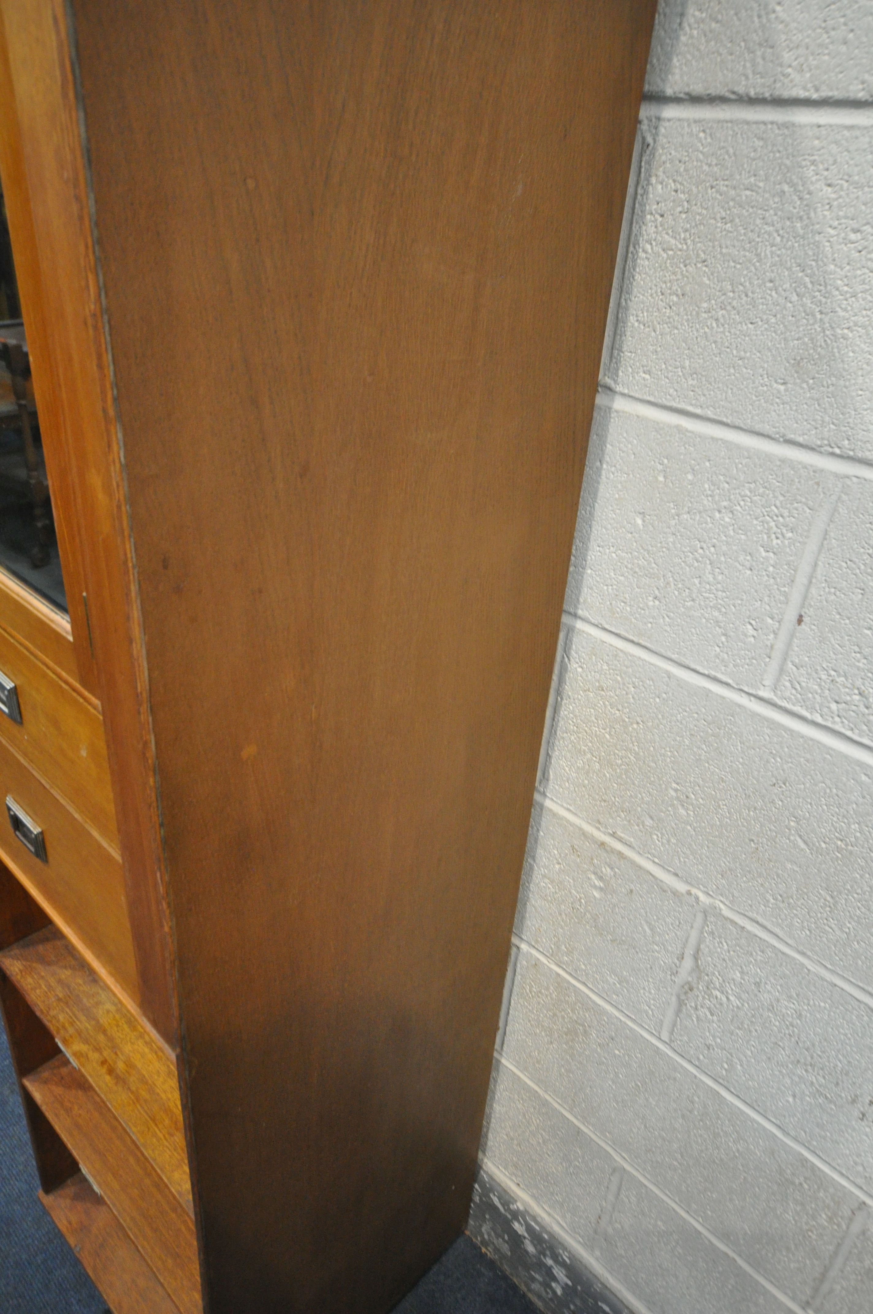 A 20TH CENTURY OAK CABINET, with a single bevelled mirror door, above two drawers and two shelves, - Image 2 of 5