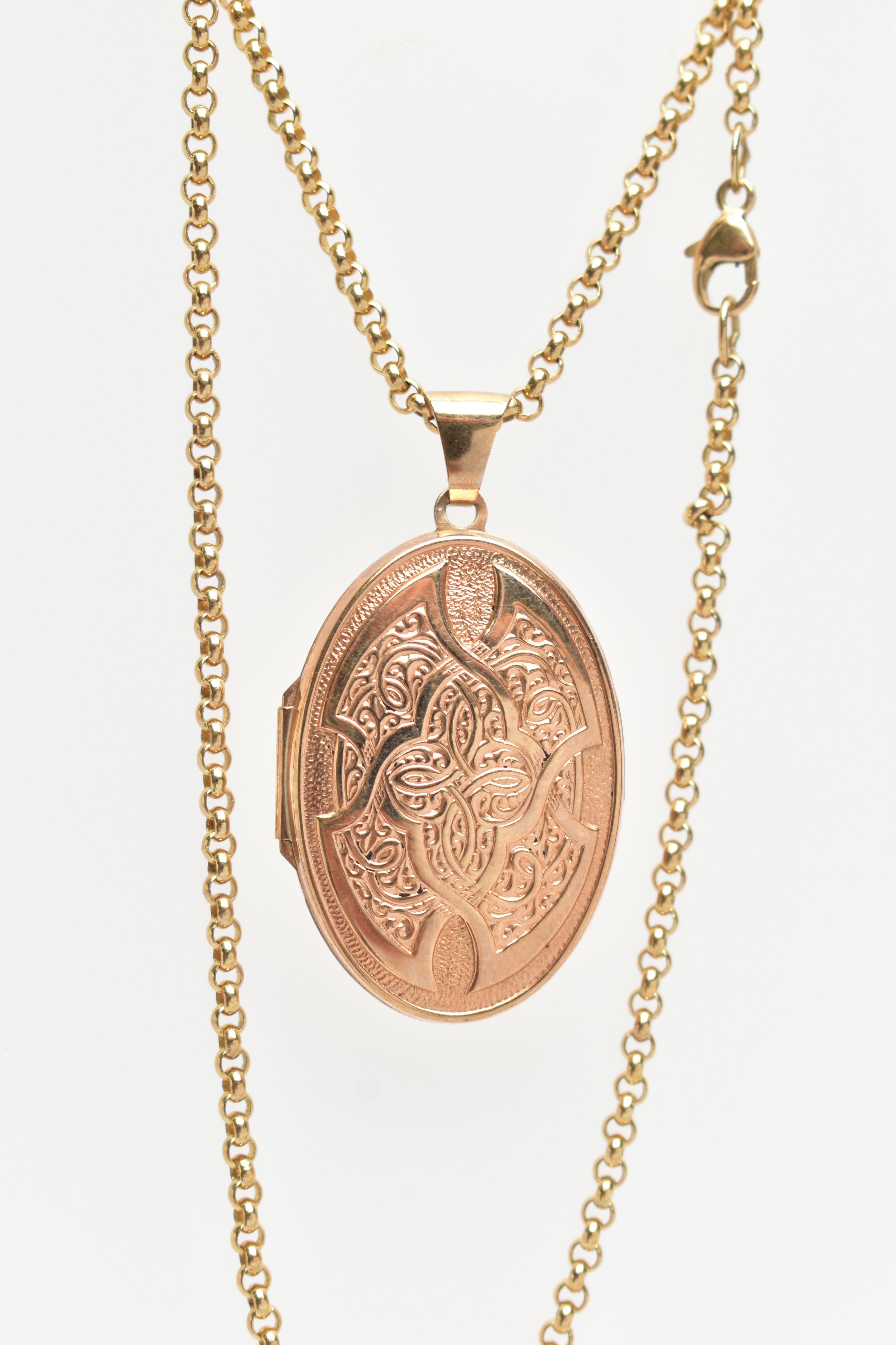 A 9CT GOLD LOCKET AND CHAIN, the hinged locket of an oval form decorated with a Celtic pattern to