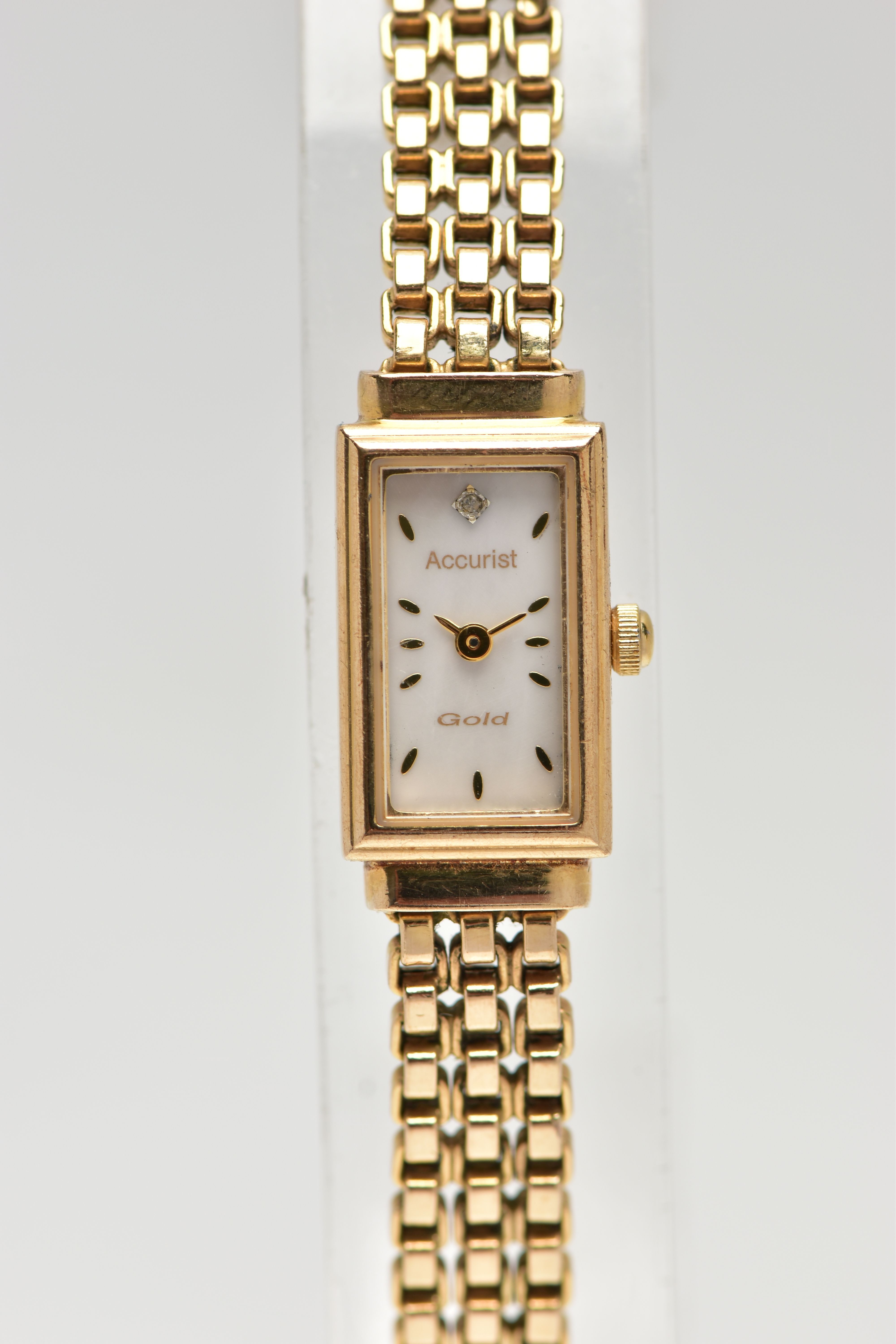 A 9CT GOLD 'ACCURIST' WRISTWATCH, quartz movement, rectangular mother of pearl dial, signed '