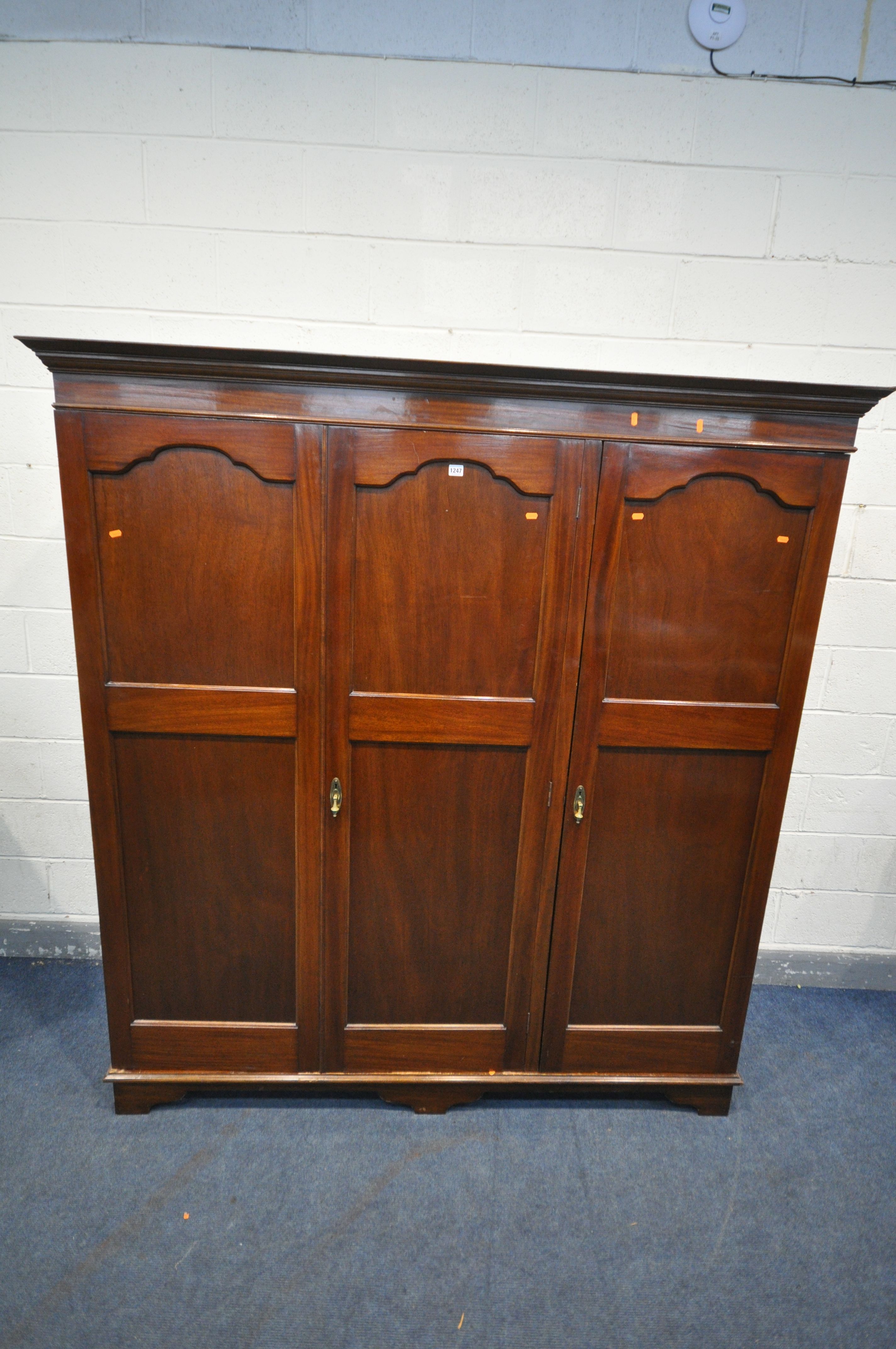 A 20TH CENTURY MAHOGANY TRIPLE DOOR WARDROBE, labelled J.Richardson & Sons, width 183cm x depth 61cm