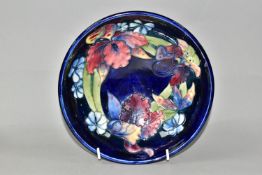 A MOORCROFT POTTERY FOOTED BOWL, in Orchid pattern, with tube lined red, yellow and navy orchids