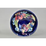 A MOORCROFT POTTERY FOOTED BOWL, in Orchid pattern, with tube lined red, yellow and navy orchids