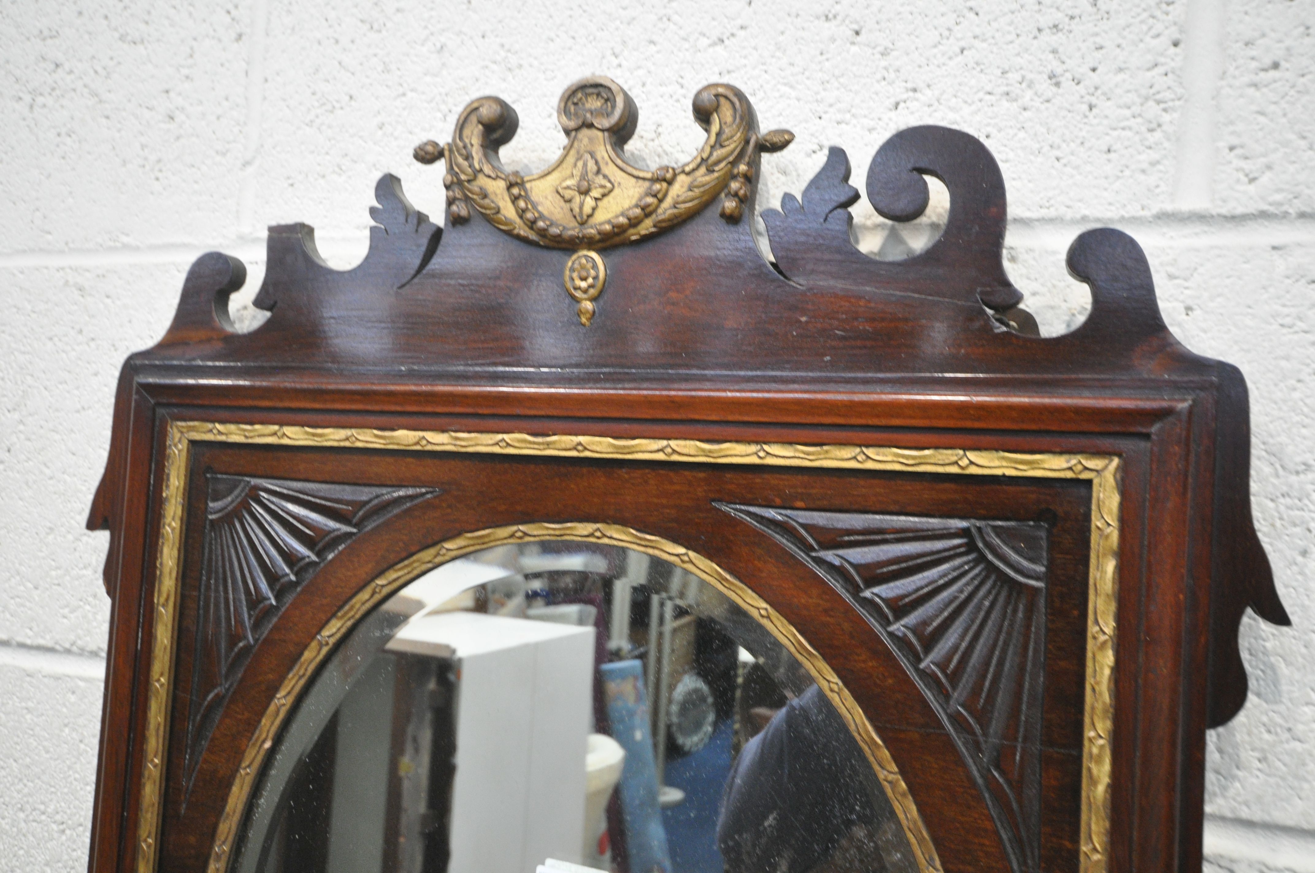 AN EARLY 19TH CENTURY MAHOGANY AND GILT FRETWORK FRAMED WALL MIRROR, with an oval bevelled plate, - Image 3 of 4