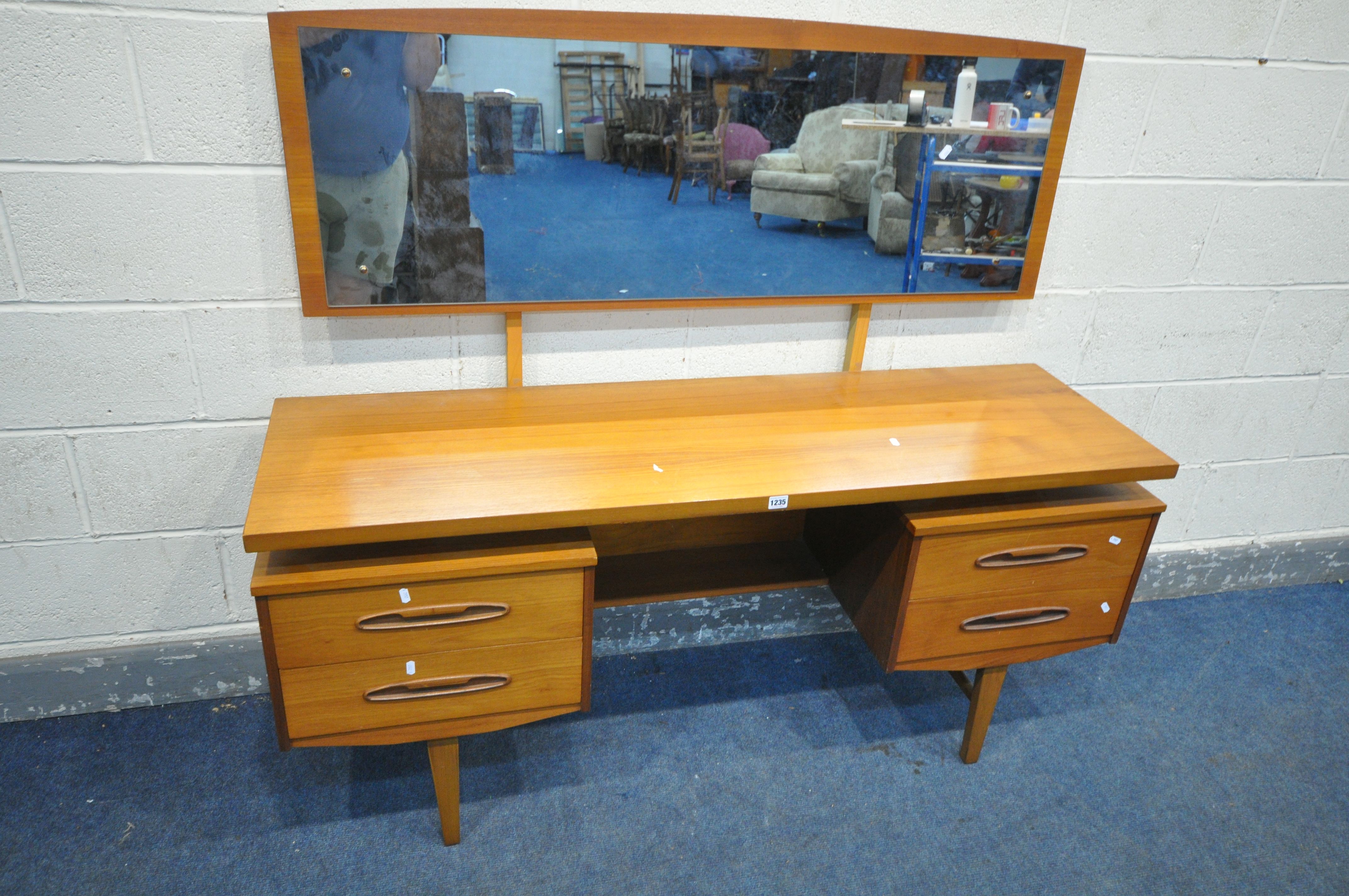 A MID CENTURY TEAK DRESSING TABLE, with a single rectangular mirror, four drawers on square tapering