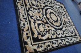 A G.H.FRITH CHINESE HANDKNOTTED BLACK GROUND RUG with brown and beige foliate detailing and a