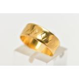 A 22CT YELLOW GOLD WIDE BAND RING, worn textured design all round, approximate band width 6.5mm,