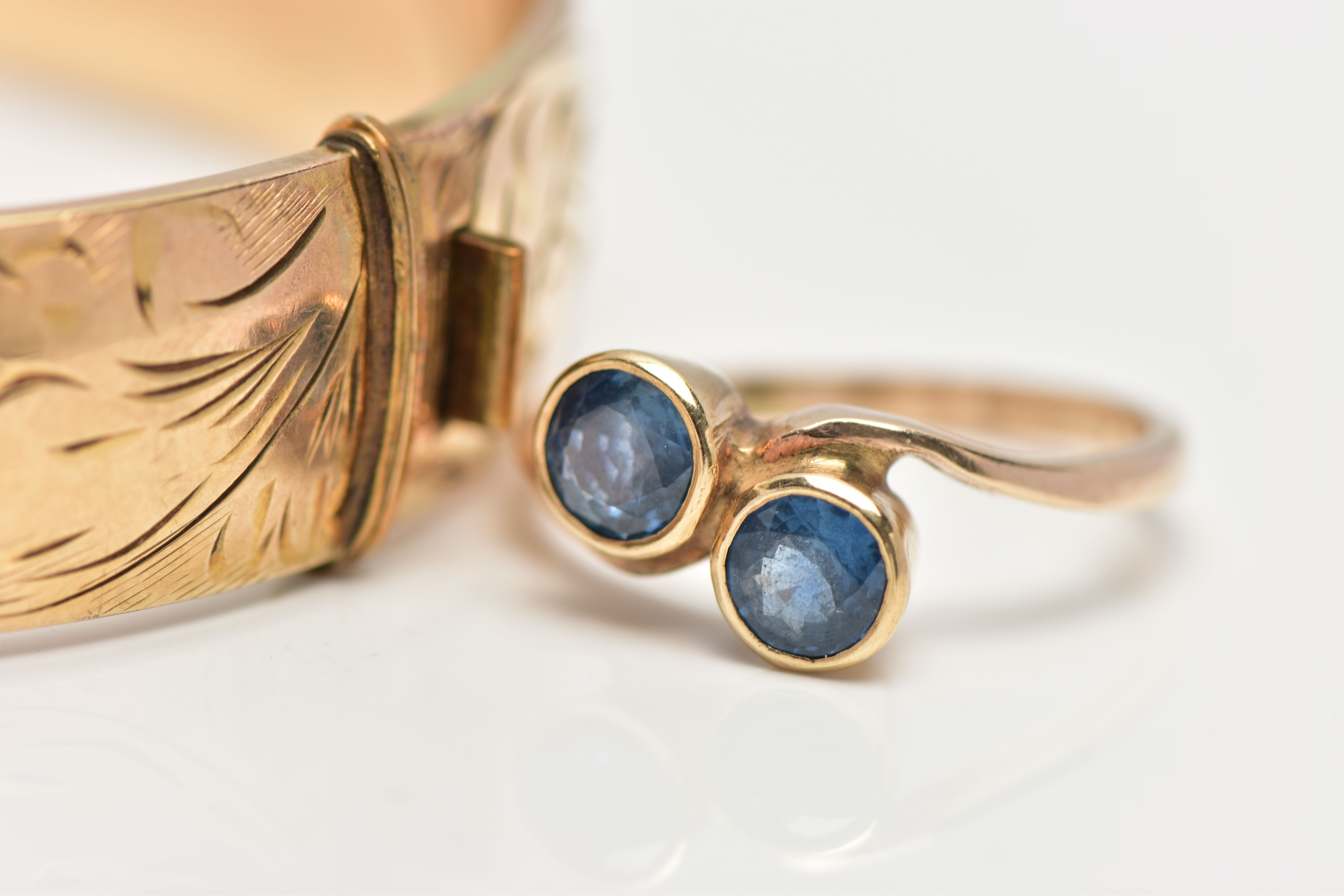 A 9CT GOLD SAPPHIRE RING AND A GOLD PLATED HINGED BANGLE, the ring of a cross over design, set - Image 2 of 4