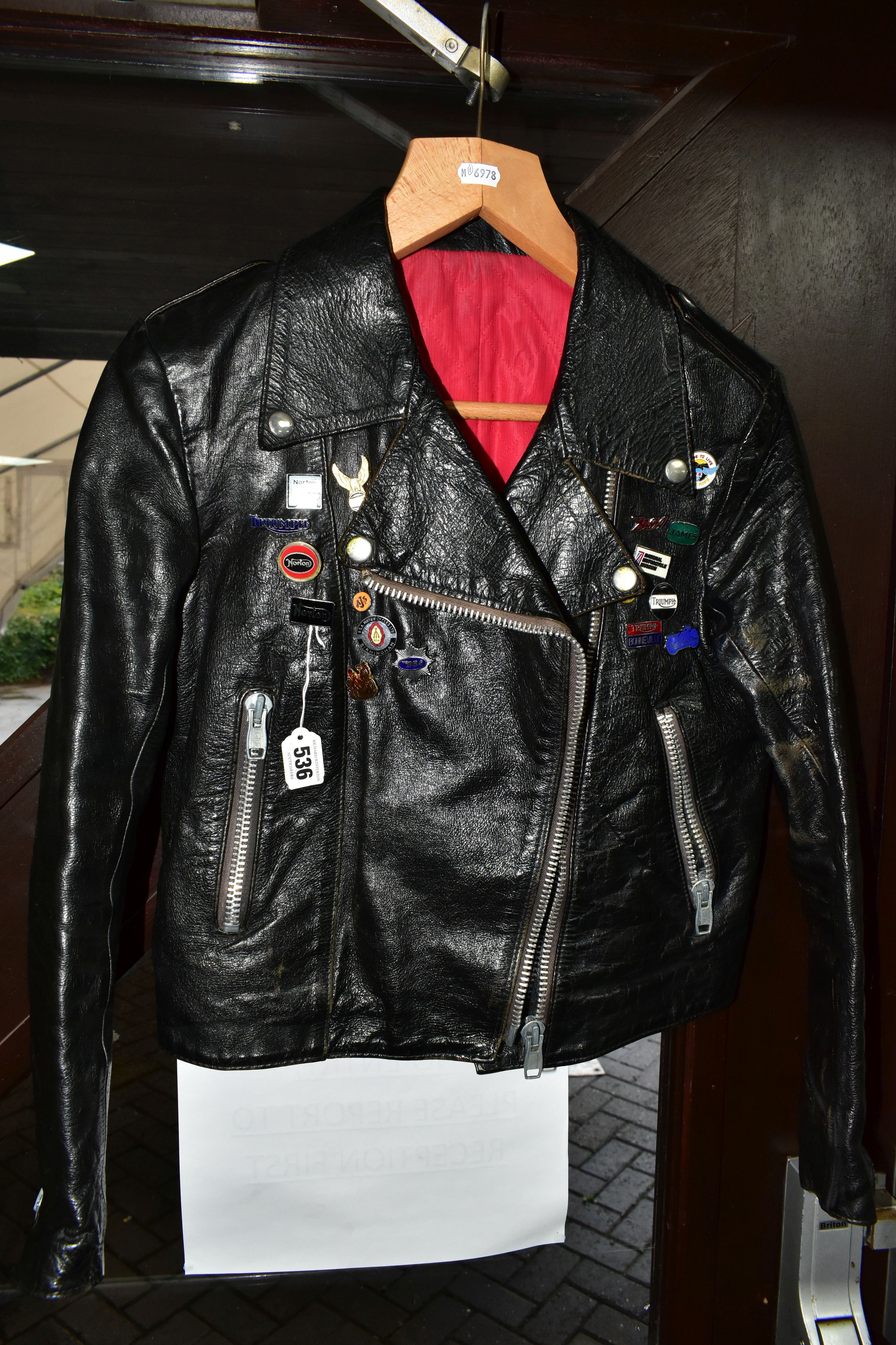 A BLACK LEATHER PIN BADGE BIKER'S JACKET, size small, Frank N Furter style, with sixteen metal pin