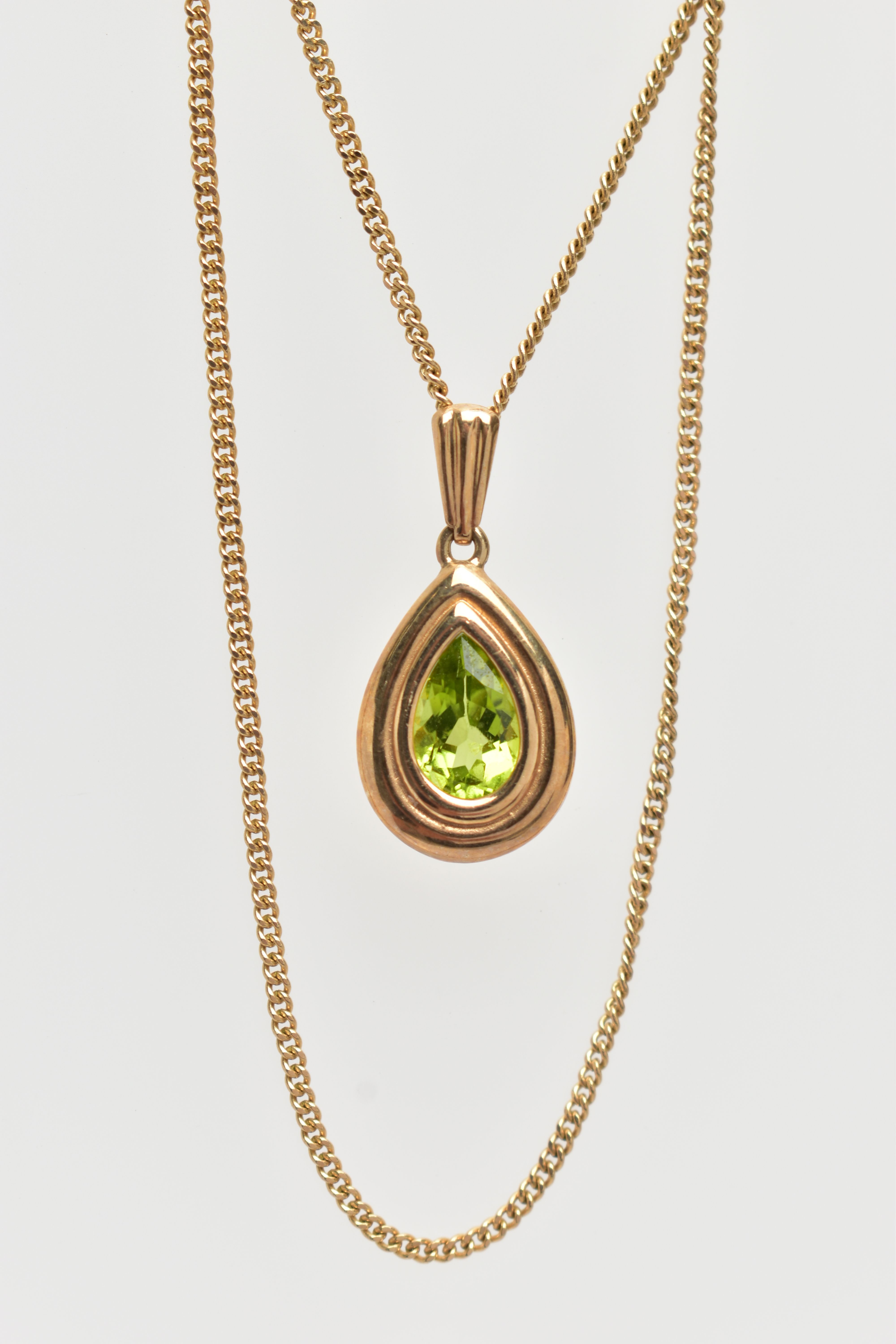 A 9CT GOLD PERIDOT PENDANT NECKLACE, the pendant of a pear drop shape, collet and claw set pear