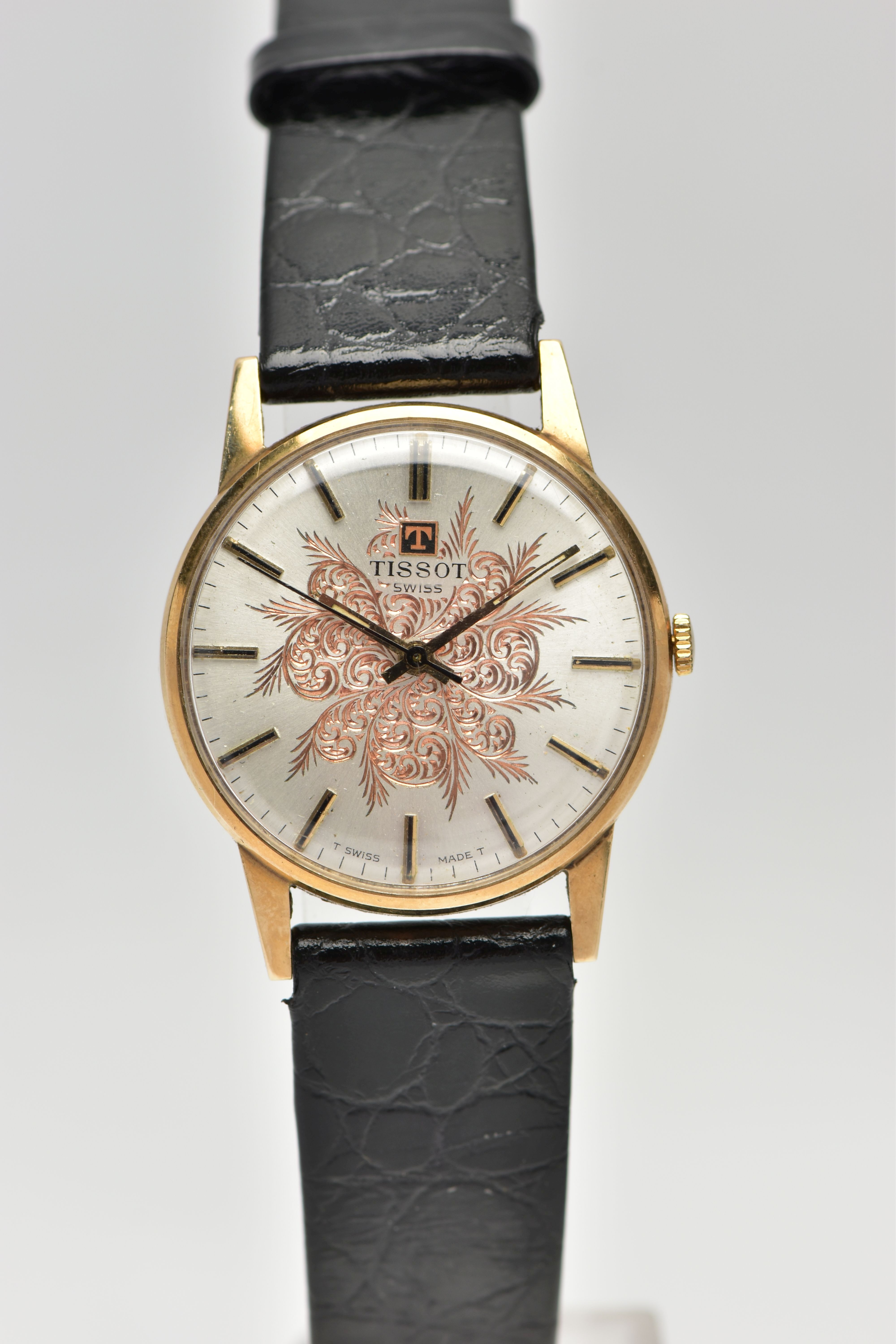 A 9CT YELLOW GOLD TISSOT WRISTWATCH, the silver coloured dial, with black enamel and gilt hourly