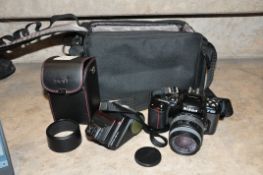 A NIKON F-601 FILM SLR CAMERA fitted with a Sigma 28-70mm f3.5 lens with case, an Osram AF281