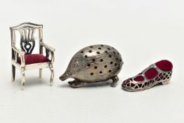 THREE WHITE METAL PIN CUSHIONS, to include a textured hedgehog, with pin holes, unmarked, a small
