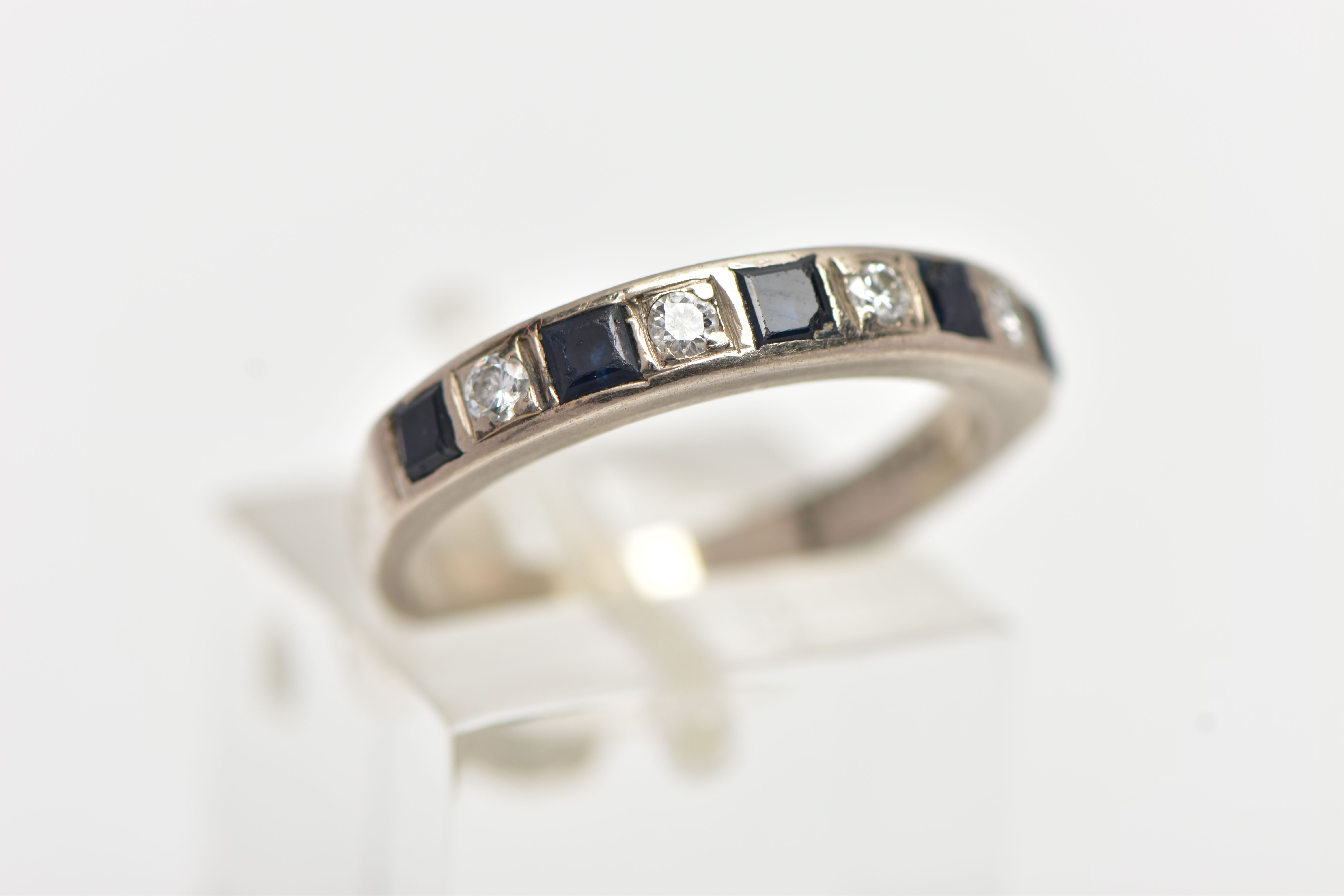 A WHITE METAL SAPPHIRE AND DIAMOND HALF ETERNITY BAND RING, set with four round brilliant cut - Image 4 of 4