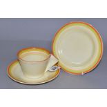 A CLARICE CLIFF FOR NEWPORT POTTERY BIZARRE TRIO, teacup, saucer and tea plate with orange, green