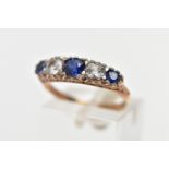 A 9CT YELLOW GOLD FIVE STONE RING, set with three circular cut blue sapphires and two circular cut