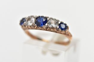A 9CT YELLOW GOLD FIVE STONE RING, set with three circular cut blue sapphires and two circular cut