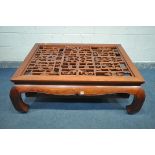 A ORIENTAL QING DYNASTY STYLE HARDWOOD COFFEE TABLE, with a central open pattern, length 140cm x