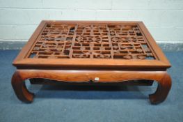 A ORIENTAL QING DYNASTY STYLE HARDWOOD COFFEE TABLE, with a central open pattern, length 140cm x