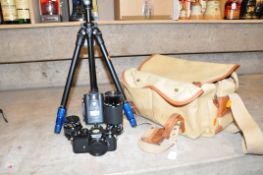 A NIKON FE FILM SLR CAMERA a Billlingham canvas camera bag, a Kiron 80-200mm f4 lens, a Kiron