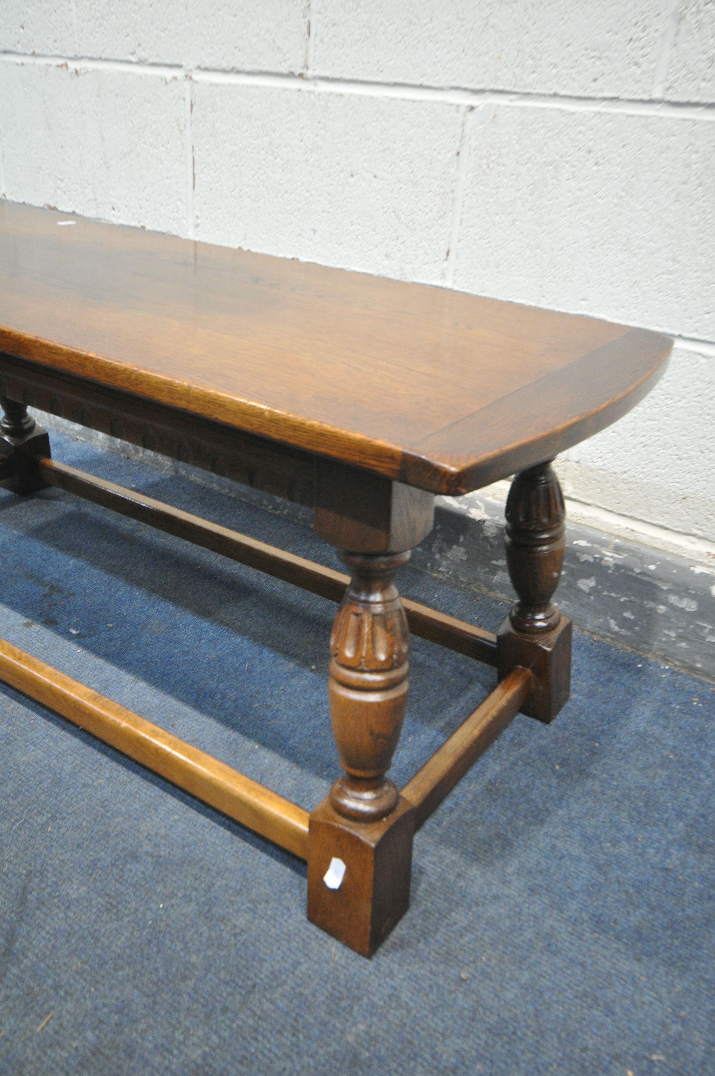 A 20TH CENTURY OAK COFFEE TABLE, on a shaped tapered support united by a box stretcher, length 106cm - Image 2 of 2