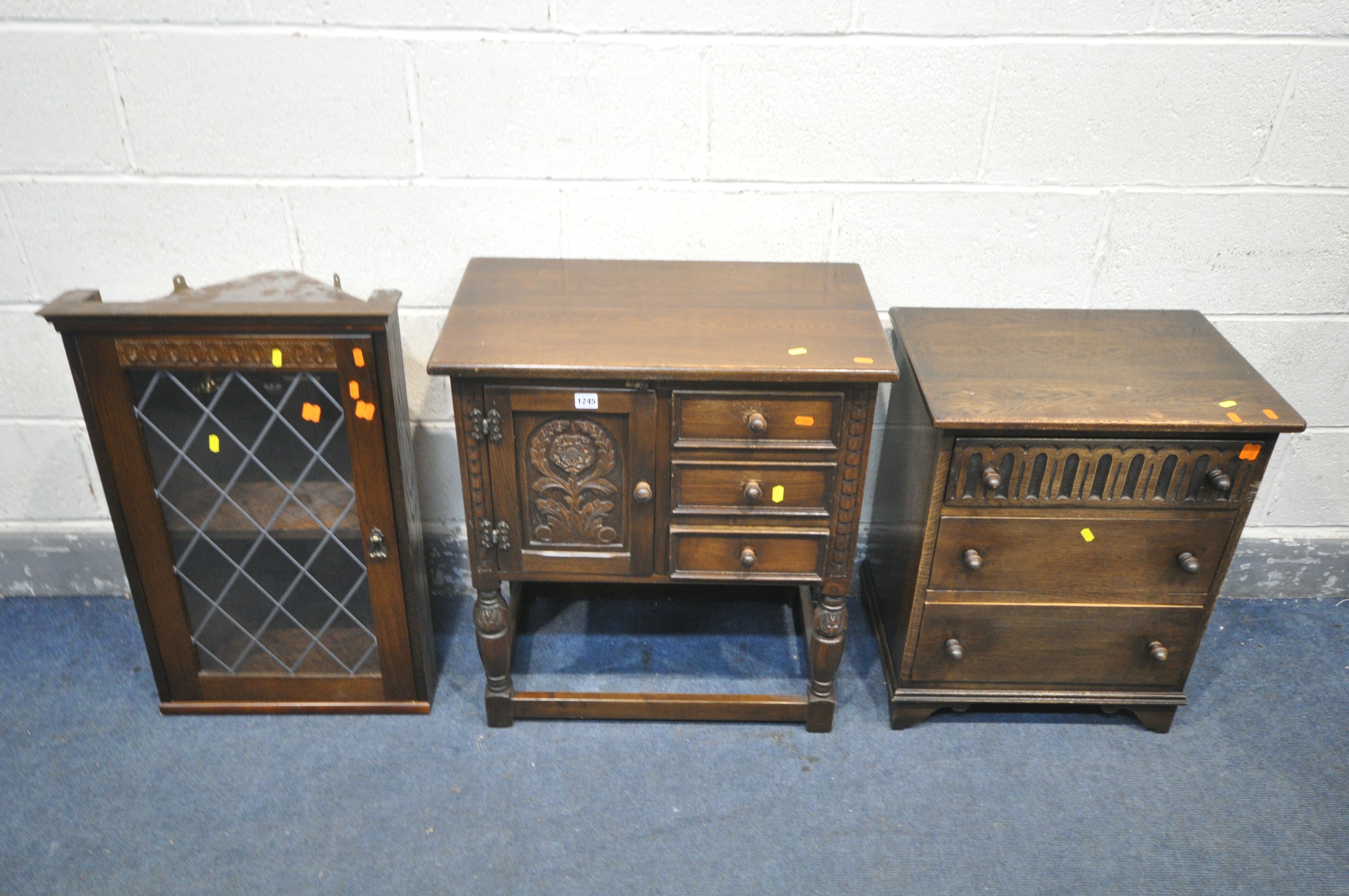 AN OAK SIDE CABINET, with a single door and three drawers, width 65cm x depth 38cm x height 73cm,