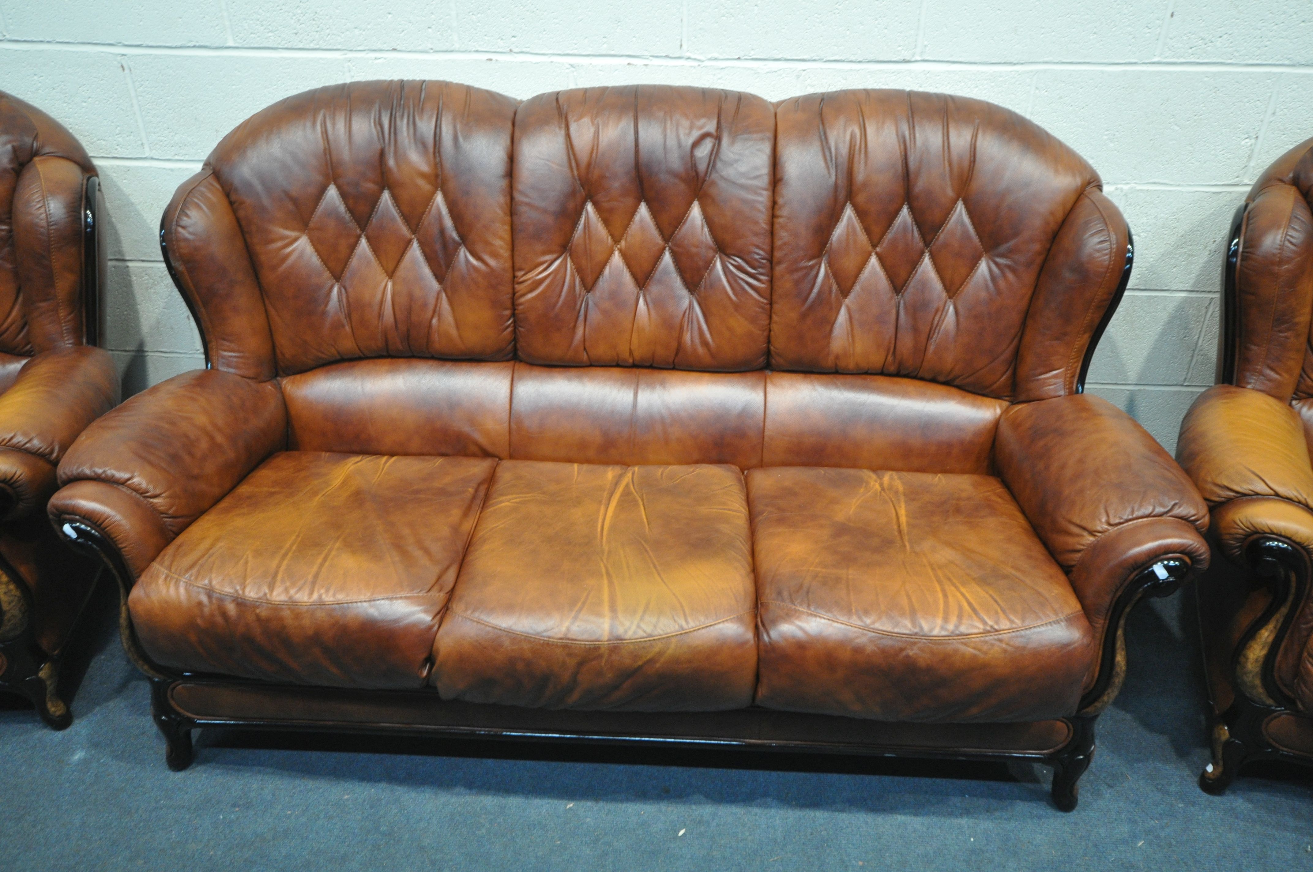 A BROWN LEATHER THREE PIECE LOUNGE SUITE, comprising a three seater sofa and a pair of armchairs ( - Image 2 of 3