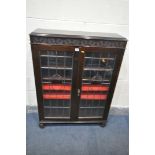 AN EDWARDIAN MAHOGANY LEAD GLAZED TWO DOOR BOOKCASE, with three original shelves, and two later