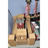 AN EARLY LEARNING CENTRE CASTLE AND PIRATE SHIP, the castle on baseboard measuring 62cm x 61cm,