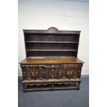 A 20TH CENTURY SOLID OAK DRESSER BASE, with three assorted drawers, central drawer with foliate