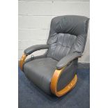 A HIMOLLA MOSEL RECLINER ARMCHAIR, covered charcoal coloured leather, on a swivel base, label to