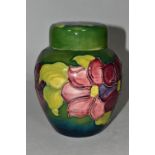 A MOORCROFT POTTERY GINGER JAR AND COVER, the green ground decorated in a red/purple clematis