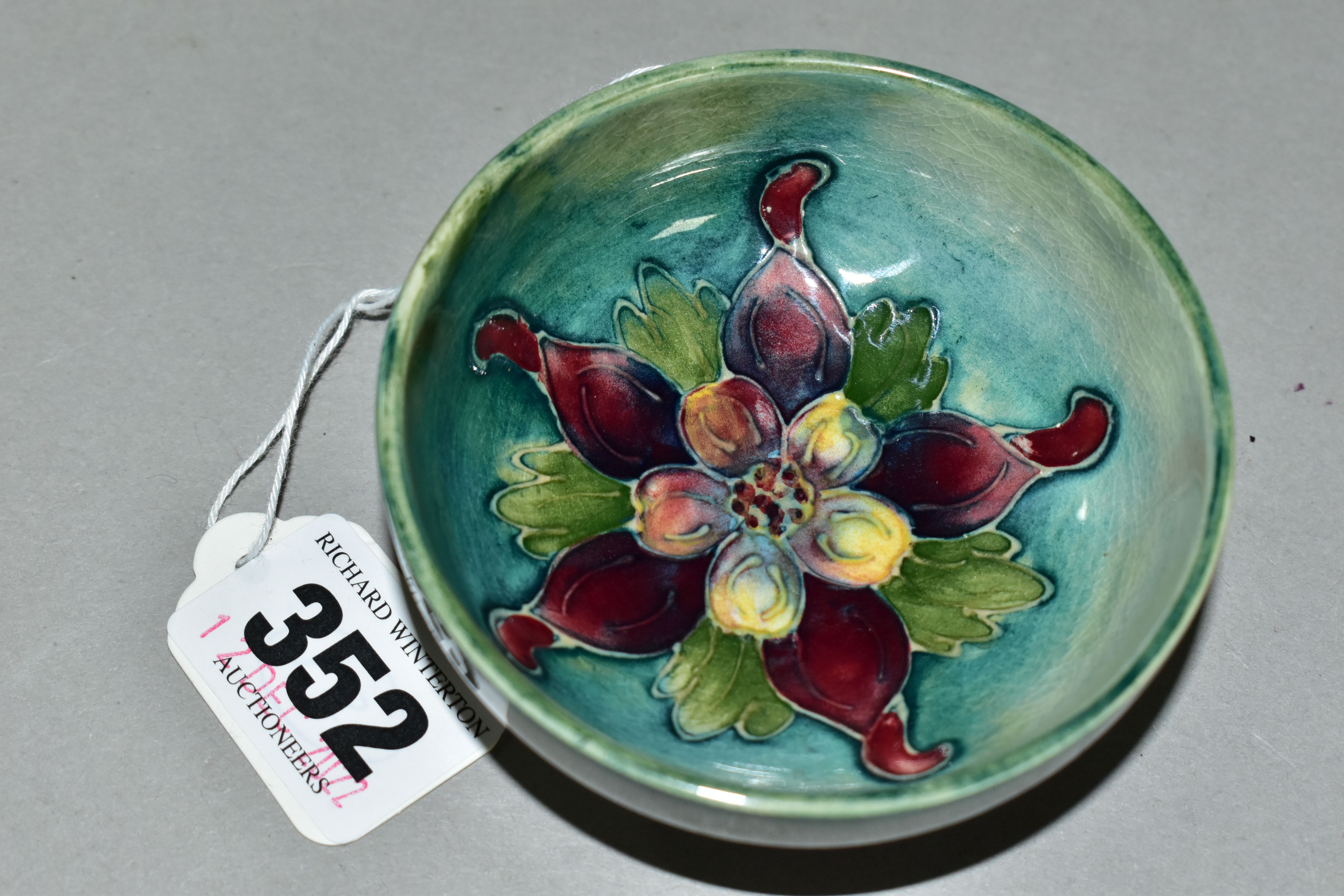 A SMALL MOORCROFT POTTERY FOOTED BOWL, 'Columbine' pattern on blue/green ground, impressed marks - Image 2 of 4