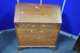 A GEORGIAN OAK FALL FRONT BUREAU, with a fitted interior, with four long graduated drawers, on