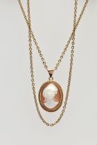 A YELLOW METAL CAMEO PENDANT NECKLACE, the pendant of an oval form, set with a carved shell cameo