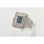 A WHITE METAL DIAMOND DRESS RING, of a rectangular form, to the centre is six princess cut blue