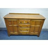 AN ERCOL OLD COLONIAL ELM TWO DOOR SIDEBOARD SIDEABORD, with four central drawers, width 147cm x