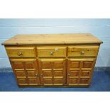A MODERN PINE SIDEBOARD, with three drawers over three cupboard doors, length 142cm x depth 52cm x
